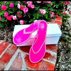 Hot pink bling flip flops.